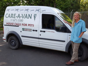 Christy standing by the CARE-A-Van van